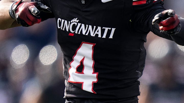 Cincinnati Bearcats wide receiver Cyrus Allen (4) gestures for a first down as Arizona Wildcats linebacker Jabari Mann (11) and Arizona Wildcats defensive back Treydan Stukes (2) react in the third quarter of the NCAA football game at Nippert Stadium in Cincinnati on Nov. 15, 2025.