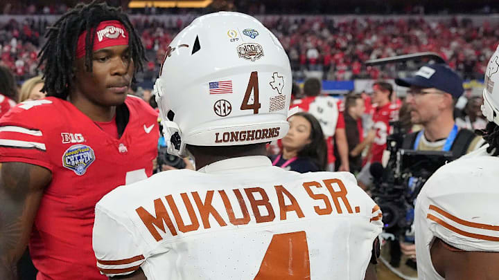 Ohio State Buckeyes wide receiver Jeremiah Smith (4) talks to Texas Longhorns defensive back Andrew Mukuba (4) after the Buckeyes beat the Longhorns 28-14 in the Cotton Bowl Classic during the College Football Playoff semifinal game at AT&T Stadium in Arlington, Texas on January, 10, 2025.