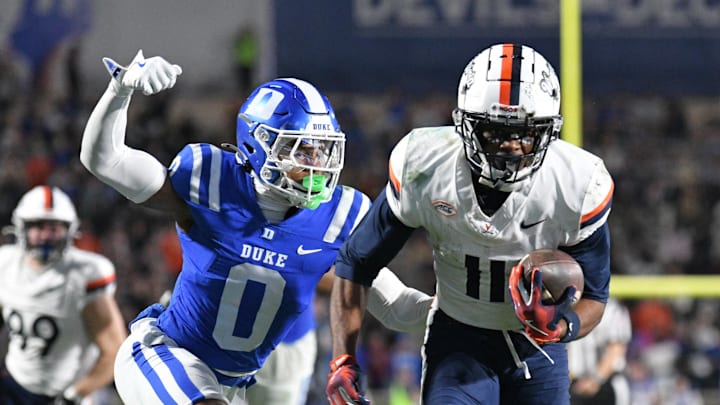 Nov 15, 2025; Durham, North Carolina, USA; Duke Blue Devils cornerback Chandler Rivers (0) attempts to swat the ball from Virginia Cavaliers wide receiver Trell Harris (11) during the third quarter at Wallace Wade Stadium. Mandatory Credit: Zachary Taft-Imagn Images Nov 15, 2025; Durham, North Carolina, USA; Duke Blue Devils cornerback Chandler Rivers (0) attempts to swat the ball from Virginia Cavaliers wide receiver Trell Harris (11) during the third quarter at Wallace Wade Stadium. Mandatory Credit: Zachary Taft-Imagn Images