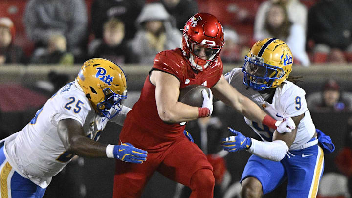 Nov 23, 2024; Louisville, Kentucky, USA;  Louisville Cardinals tight end Nate Kurisky (85) runs against Pittsburgh Panthers defensive lineman Jahsear Whittington (25) and linebacker Kyle Louis (9) during the second half at L&N Federal Credit Union Stadium. Louisville defeated Pittsburgh 37-9. Mandatory Credit: Jamie Rhodes-Imagn Images