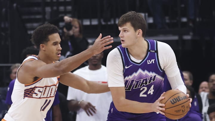 Oct 27, 2025; Salt Lake City, Utah, USA; Utah Jazz center Walker Kessler (24) looks to pass against Phoenix Suns forward Oso Ighodaro (11) during the first quarter at Delta Center. Mandatory Credit: Rob Gray-Imagn Images