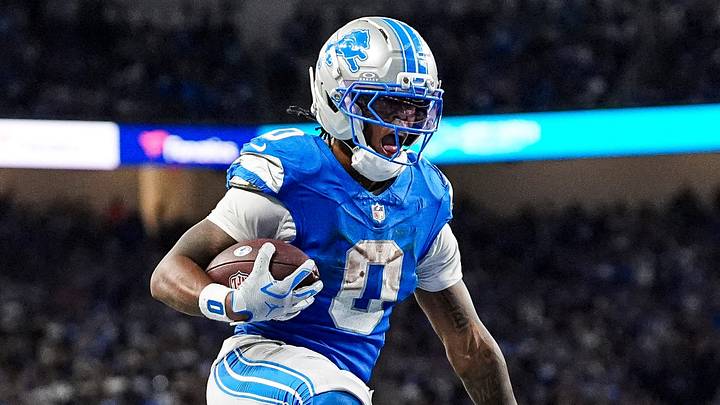 Detroit Lions running back Jahmyr Gibbs (0) leaps into the end zone
