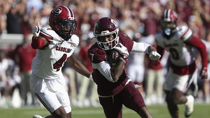Nov 15, 2025; College Station, Texas, USA; Texas A&M Aggies wide receiver KC Concepcion (7) runs with the ball past South Carolina Gamecocks defensive back Vicari Swain (4) during the fourth quarter at Kyle Field. Mandatory Credit: Troy Taormina-Imagn Images