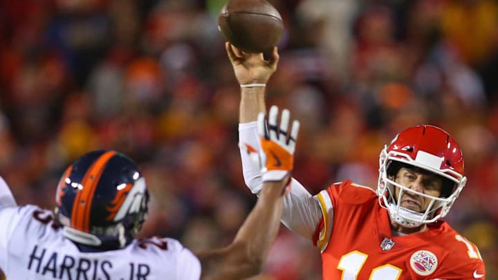 Oct 30, 2017; Kansas City, MO, USA; Kansas City Chiefs quarterback Alex Smith (11) throws a pass as Denver Broncos cornerback Chris Harris (25) defends in the second half at Arrowhead Stadium. Mandatory Credit: Jay Biggerstaff-Imagn Images