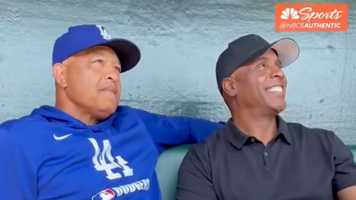 Los Angeles Dodgers manager Dave Roberts sits with Barry Bonds at the San Francisco Giants game.