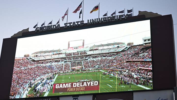 The videoboard announces the game between the Florida State Seminoles and the Southern Methodist Mustangs is delayed due to power outage at Doak S. Campbell Stadium. 