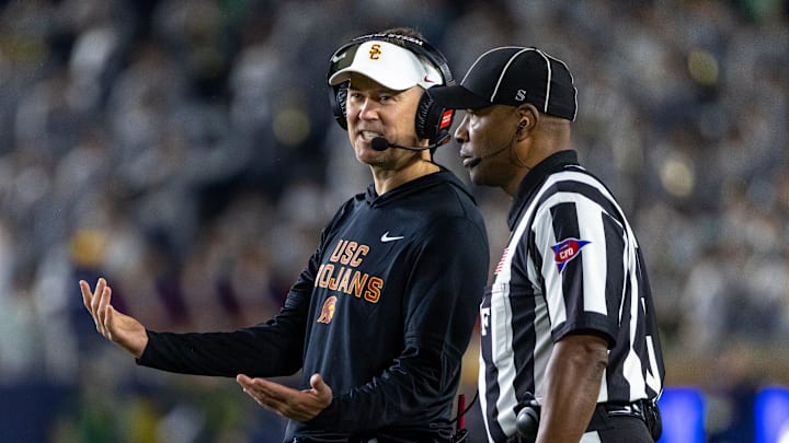 Oct 18, 2025; South Bend, Indiana, USA; Southern California Trojans head coach Lincoln Riley talks to an official during the first half against the Notre Dame Fighting Irish at Notre Dame Stadium. 