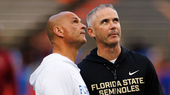 Nov 29, 2025; Gainesville, Florida, USA; Florida Gators interim head coach Billy Gonzales and Florida State Seminoles head coach Mike Norvell talk before the game at Ben Hill Griffin Stadium. Mandatory Credit: Matt Pendleton-Imagn Images Nov 29, 2025; Gainesville, Florida, USA; Florida Gators interim head coach Billy Gonzales and Florida State Seminoles head coach Mike Norvell talk before the game at Ben Hill Griffin Stadium. Mandatory Credit: Matt Pendleton-Imagn Images