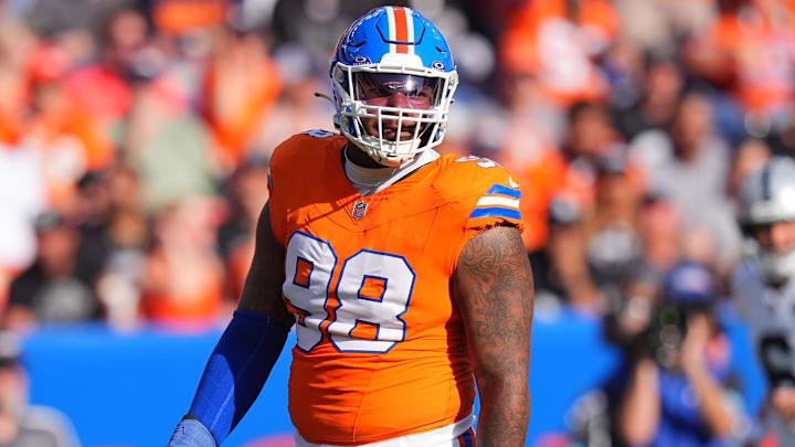 Oct 6, 2024; Denver, Colorado, USA; Denver Broncos defensive end John Franklin-Myers (98) reacts to a defensive stop in the second half against the Las Vegas Raiders at Empower Field at Mile High. 