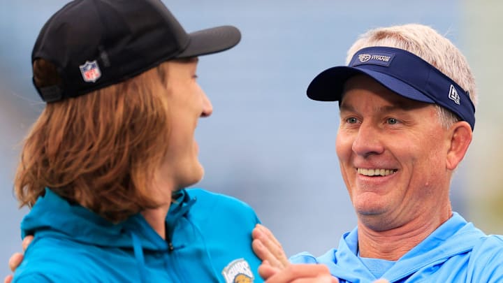 Jacksonville Jaguars quarterback Trevor Lawrence (16), left, is surprised by Tennessee Titans head coach Mike McCoy before an NFL football matchup at EverBank Stadium, Sunday, Jan. 4, 2026, in Jacksonville, Fla. [Corey Perrine/Florida Times-Union]