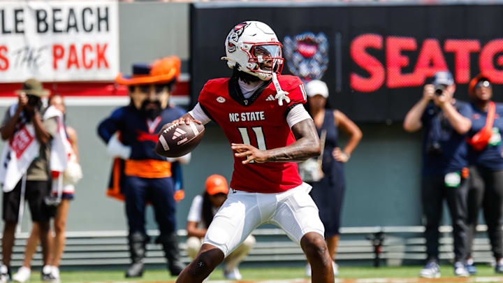 Sep 6, 2025; Raleigh, North Carolina, USA; North Carolina State Wolfpack quarterback CJ Bailey (11) prepares to throw the football during the first half of the game against Virginia Cavaliers at Carter-Finley Stadium. Mandatory Credit: Jaylynn Nash-Imagn Images