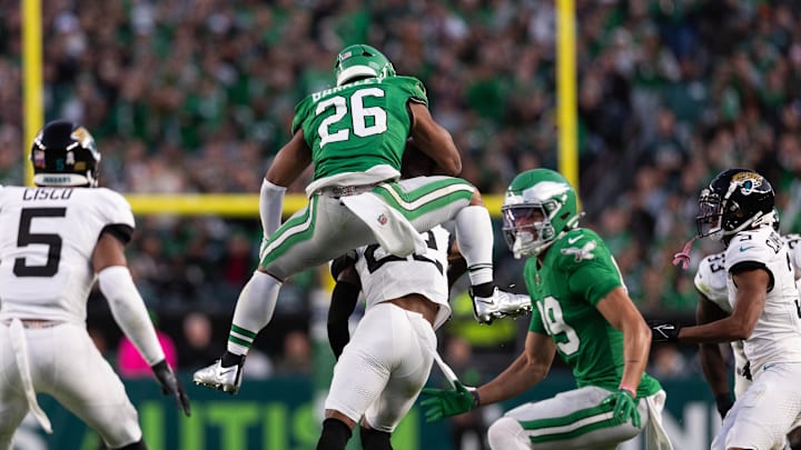 Nov 3, 2024; Philadelphia, Pennsylvania, USA; Philadelphia Eagles running back Saquon Barkley (26) leaps backwards over Jacksonville Jaguars cornerback Jarrian Jones (22) at Lincoln Financial Field. Mandatory Credit: Bill Streicher-Imagn Images