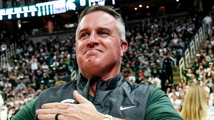 Michigan State's new football coach Pat Fitzgerald pats his heart at the crowd in attendance for the Spartans basketball game against Iowa on Tuesday, Dec. 2, 2025, at the Breslin Center in East Lansing. Michigan State's new football coach Pat Fitzgerald pats his heart at the crowd in attendance for the Spartans basketball game against Iowa on Tuesday, Dec. 2, 2025, at the Breslin Center in East Lansing.