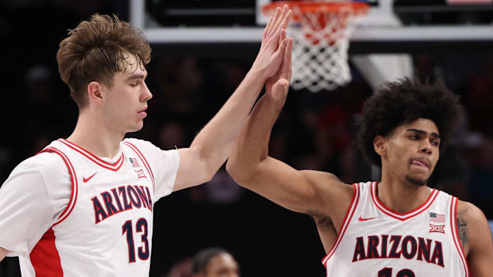 Mar 14, 2026; Kansas City, MO, USA; Arizona Wildcats center Motiejus Krivas (13) and forward Koa Peat (10) high-five during the second half against the Houston Cougars during the men's Big 12 Conference Tournament Championship at T-Mobile Center. Mandatory Credit: William Purnell-Imagn Images Mar 14, 2026; Kansas City, MO, USA; Arizona Wildcats center Motiejus Krivas (13) and forward Koa Peat (10) high-five during the second half against the Houston Cougars during the men's Big 12 Conference Tournament Championship at T-Mobile Center. Mandatory Credit: William Purnell-Imagn Images