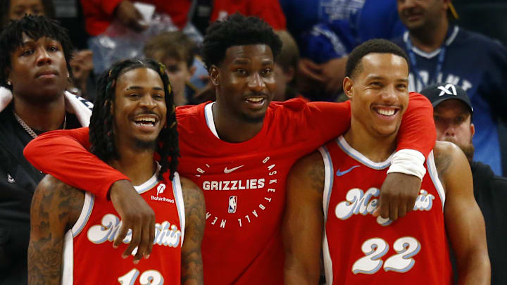 Dec 19, 2024; Memphis, Tennessee, USA; Memphis Grizzlies guard Ja Morant (left), forward Jaren Jackson Jr. (middle) and guard Desmond Bane (right) react during the fourth quarter against the Golden State Warriors at FedExForum. Mandatory Credit: Petre Thomas-Imagn Images