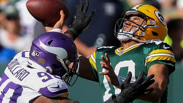 Green Bay Packers quarterback Jordan Love (10) throws the ball under pressure from Vikings defensive end Jonathan Bullard.