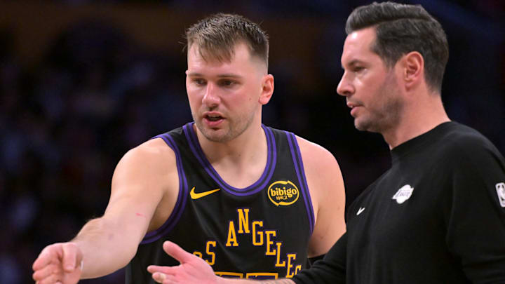 Jan 2, 2026; Los Angeles, California, USA; Los Angeles Lakers guard Luka Doncic (77) talks with head coach JJ Redick during a time out in the second half against the Memphis Grizzlies at Crypto.com Arena. Mandatory Credit: Jayne Kamin-Oncea-Imagn Images