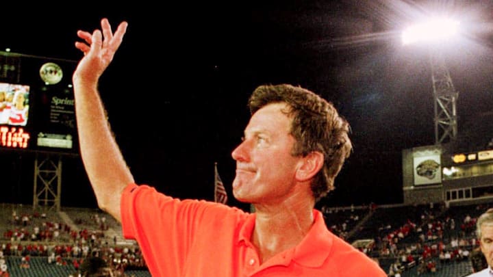Florida head coach Steve Spurrier  waves to the crowd after singing the school's alma mater after the Gators beat Georgia in Jacksonville, Florida on October 31,1998.