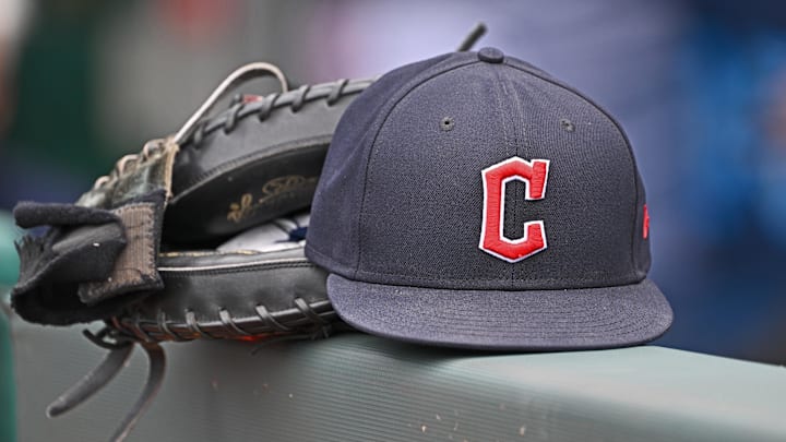 Jun 27, 2024; Kansas City, Missouri, USA; A general view a Cleveland Guardians hat and glove on the dugout railing  before a game against the Kansas City Royals at Kauffman Stadium. 