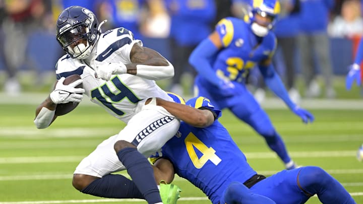 Jan 5, 2025; Inglewood, California, USA; Seattle Seahawks wide receiver DK Metcalf (14) is stopped by Los Angeles Rams cornerback Ahkello Witherspoon (4) after a complete pass in the first half at SoFi Stadium. Jan 5, 2025; Inglewood, California, USA; Seattle Seahawks wide receiver DK Metcalf (14) is stopped by Los Angeles Rams cornerback Ahkello Witherspoon (4) after a complete pass in the first half at SoFi Stadium.