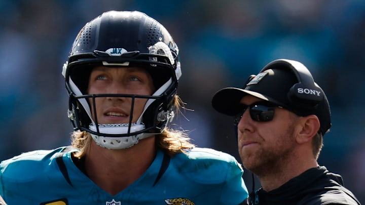 Jacksonville Jaguars quarterback Trevor Lawrence (16) and Jacksonville Jaguars head coach Liam Coen wait to see the result of a challenge during the second quarter in an NFL football AFC Wild Card playoff matchup, Sunday, Jan. 11, 2026, in Jacksonville, Fla. Bills lead 10-7 at the half over the Jaguars. [Doug Engle/Florida Times-Union]