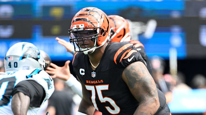 Sep 29, 2024; Charlotte, North Carolina, USA; Cincinnati Bengals offensive tackle Orlando Brown Jr. (75) blocks as Carolina Panthers linebacker Charles Harris (40) rushes in the first quarter at Bank of America Stadium. Mandatory Credit: Bob Donnan-Imagn Images