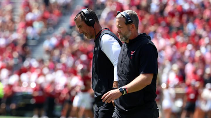 Sep 13, 2025; Tuscaloosa, Alabama, USA; Wisconsin Badgers head coach Luke Fickell converses with an assistant during the second quarter against the Alabama Crimson Tide at Saban Field at Bryant-Denny Stadium.