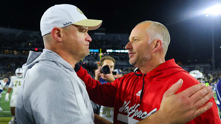 Nov 21, 2024; Atlanta, Georgia, USA; Georgia Tech Yellow Jackets head coach Brent Key talks to North Carolina State Wolfpack head coach Dave Doeren after a game at Bobby Dodd Stadium at Hyundai Field. Mandatory Credit: Brett Davis-Imagn Images
