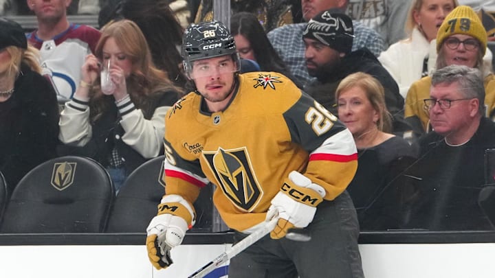 Dec 27, 2025; Las Vegas, Nevada, USA; Vegas Golden Knights right wing Alexander Holtz (26) avoids a Colorado Avalanche dump in during the first period at T-Mobile Arena. Mandatory Credit: Stephen R. Sylvanie-Imagn Images