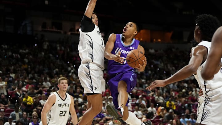 Jul 14, 2025; Las Vegas, NV, USA;  Utah Jazz forward John Tonje (17) drives towards the basket against San Antonio Spurs forward Carter Bryant (11) during the first half of a NBA basketball game at the Thomas & Mack Center. Mandatory Credit: Lucas Peltier-Imagn Images