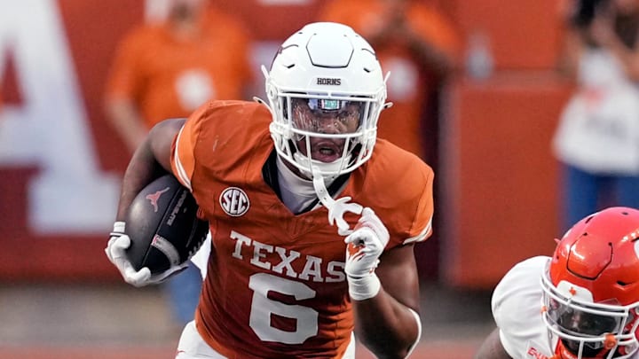 Sep 20, 2025; Austin, Texas, USA; Texas Longhorns running back Christian Clark (6) runs for yards past Sam Houston Bearkats defensive lineman Darius Jackson (90) during the first half at Darrell K Royal-Texas Memorial Stadium. Mandatory Credit: Scott Wachter-Imagn Images