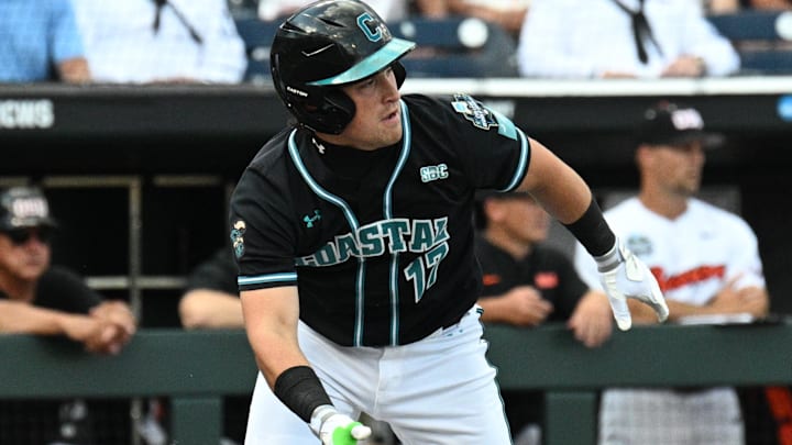 Jun 15, 2025; Omaha, Neb, USA;  Coastal Carolina Chanticleers catcher Caden Bodine (17) reaches on an infield error by the Oregon State Beavers during the first inning at Charles Schwab Field.