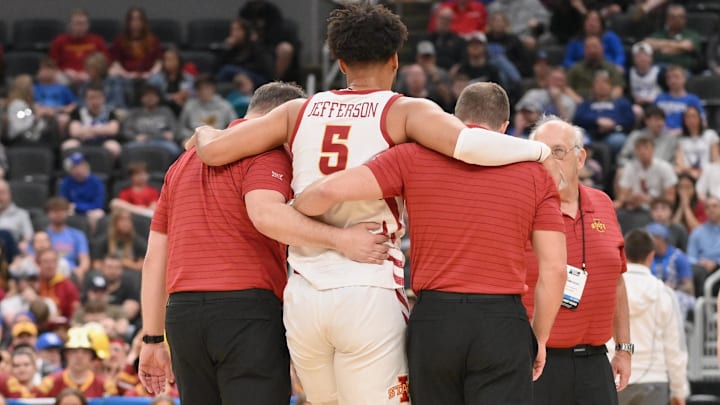 Mar 20, 2026; St. Louis, MO, USA; Iowa State Cyclones forward Joshua Jefferson (5) is helped off of the court after suffering an apparent injury to his left leg against Tennessee State Tigers during the first half of a first round game of the men's 2026 NCAA Tournament at Enterprise Center.