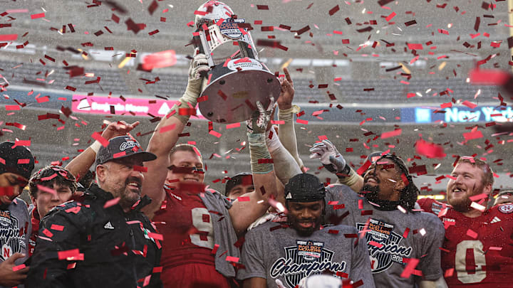 Matt Rhule and players celebrate after the Pinstripe Bowl win.