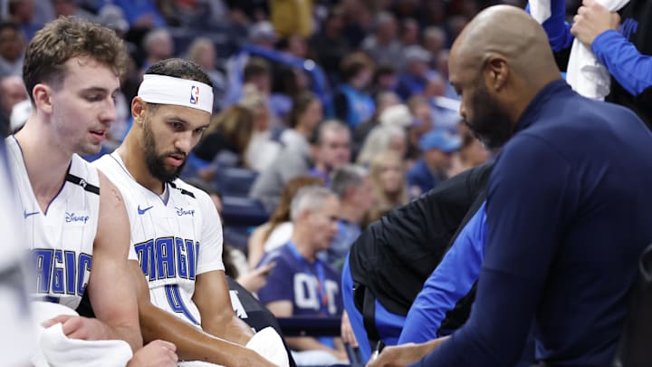 Nov 4, 2024; Oklahoma City, Oklahoma, USA; Orlando Magic guard Jalen Suggs (4) and forward Franz Wagner (22) listen to head coach Jamahl Mosley during a time out against the Oklahoma City Thunder in the second half at Paycom Center. Mandatory Credit: Alonzo Adams-Imagn Images