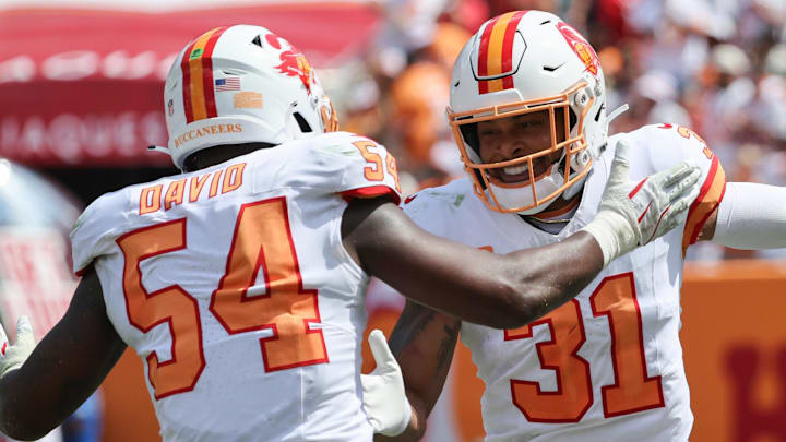 Sep 21, 2025; Tampa, Florida, USA; Tampa Bay Buccaneers safety Antoine Winfield Jr. (31) is congratulated by outside linebacker Lavonte David (54) after he forces a fumble against the Tampa Bay Buccaneer against the New York Jets during the second quarter at Raymond James Stadium. Mandatory Credit: Kim Klement Neitzel-Imagn Images