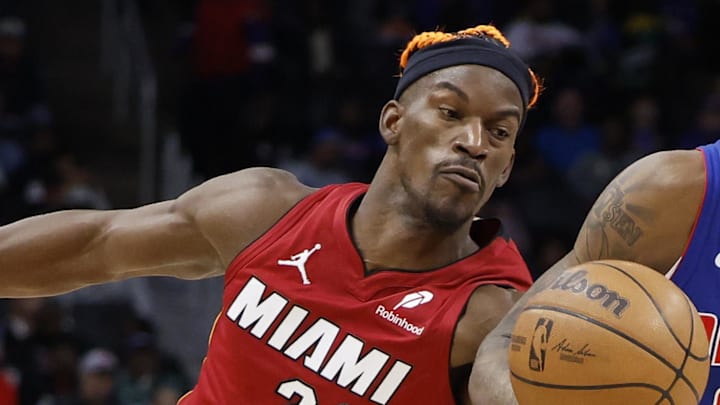 Dec 16, 2024; Detroit, Michigan, USA;  Miami Heat forward Jimmy Butler (22) knocks the ball away from Detroit Pistons forward Ronald Holland II (00) in the second half at Little Caesars Arena. Mandatory Credit: Rick Osentoski-Imagn Images