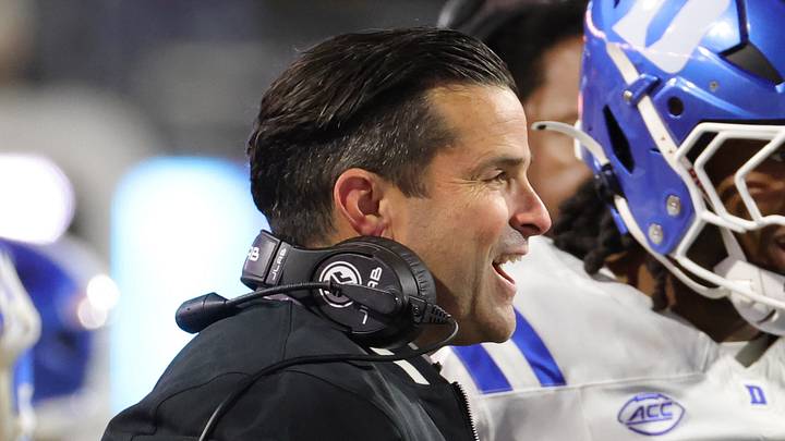 Oct 23, 2026; Charlottesville, Virginia, USA; Duke Blue Devils head coach Manny Diaz (center) celebrates with players after a play against the Virginia Cavaliers during the second half at Scott Stadium. Mandatory Credit: Amber Searls-Imagn Images