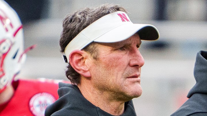 Nov 28, 2025; Lincoln, Nebraska, USA; Nebraska Cornhuskers assistant coach Mike Ekeler (left) watches warmups before the game against the Iowa Hawkeyes at Memorial Stadium. Mandatory Credit: Dylan Widger-Imagn Images