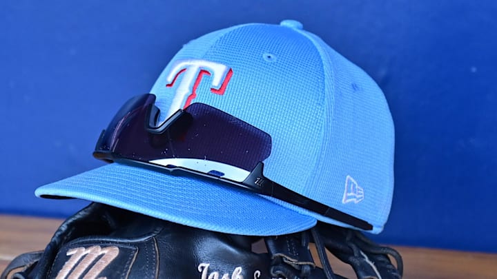 Mar 15, 2024; Salt River Pima-Maricopa, Arizona, USA; General view of a Texas Rangers hat, glove, and glasses prior to a spring training game against the Colorado Rockies at Salt River Fields at Talking Stick. 