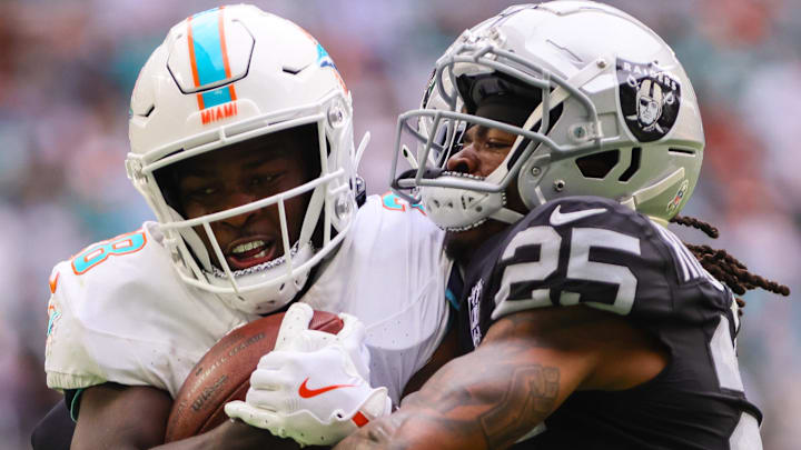 Nov 17, 2024; Miami Gardens, Florida, USA; Miami Dolphins running back De'Von Achane (28) runs with the football against Las Vegas Raiders cornerback Decamerion Richardson (25) during the third quarter at Hard Rock Stadium. Mandatory Credit: Sam Navarro-Imagn Images Nov 17, 2024; Miami Gardens, Florida, USA; Miami Dolphins running back De'Von Achane (28) runs with the football against Las Vegas Raiders cornerback Decamerion Richardson (25) during the third quarter at Hard Rock Stadium. Mandatory Credit: Sam Navarro-Imagn Images