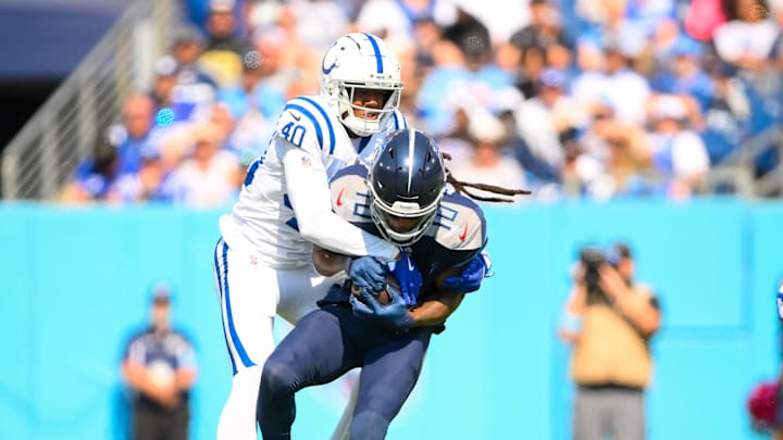 Oct 13, 2024; Nashville, Tennessee, USA;  Indianapolis Colts cornerback Jaylon Jones (40) tackles Tennessee Titans wide receiver DeAndre Hopkins (10) after a made catch during the first half at Nissan Stadium. Mandatory Credit: Steve Roberts-Imagn Images