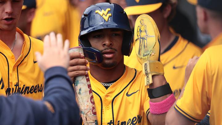 West Virginia Mountaineers junior Armani Guzman (5) is celebrated after scoring a run against Kansas Jayhawks during the game inside Hoglund Ballpark on May 10, 2026.