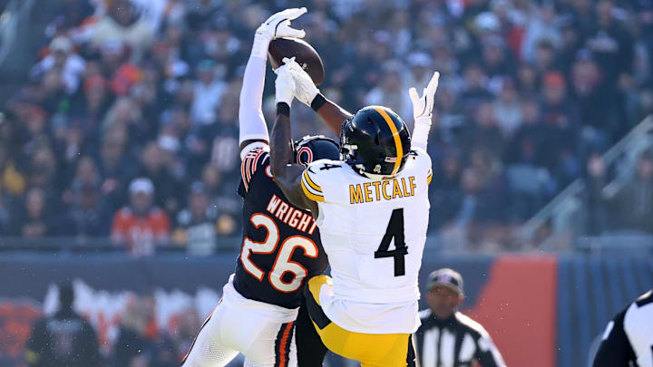 Nov 23, 2025; Chicago, Illinois, USA; Chicago Bears cornerback Nahshon Wright (26) intercepts a pass against Pittsburgh Steelers wide receiver DK Metcalf (4) during the first half at Soldier Field. Mandatory Credit: Mike Dinovo-Imagn Images