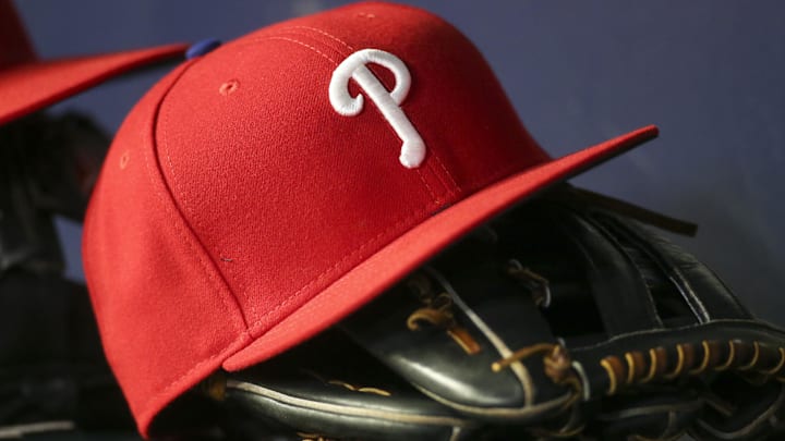 May 25, 2022; Atlanta, Georgia, USA; Detailed view of a Philadelphia Phillies hat and glove in the dugout against the Atlanta Braves in the eighth inning at Truist Park.
