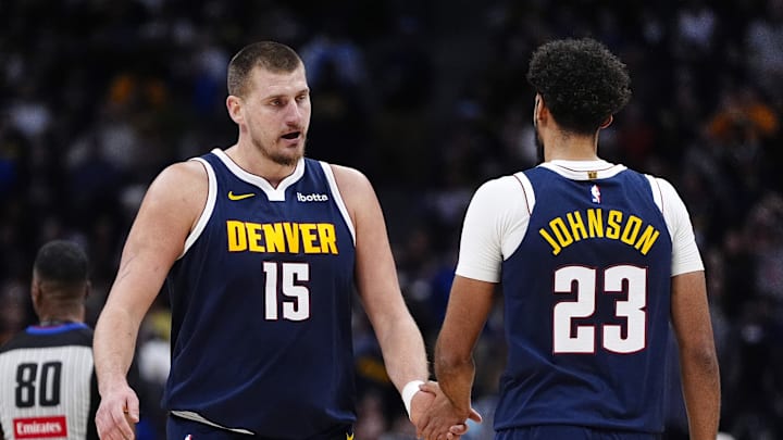 Dec 15, 2025; Denver, Colorado, USA; Denver Nuggets forward Cameron Johnson (23) and center Nikola Jokic (15) in the second quarter against the Houston Rockets at Ball Arena.