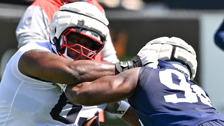 Jul 23, 2025; Foxborough, MA, USA; New England Patriots guard Mehki Butler (63) does a drill with defensive tackle David Olajija (96) during training camp at Gillette Stadium. Mandatory Credit: Eric Canha-Imagn Images
