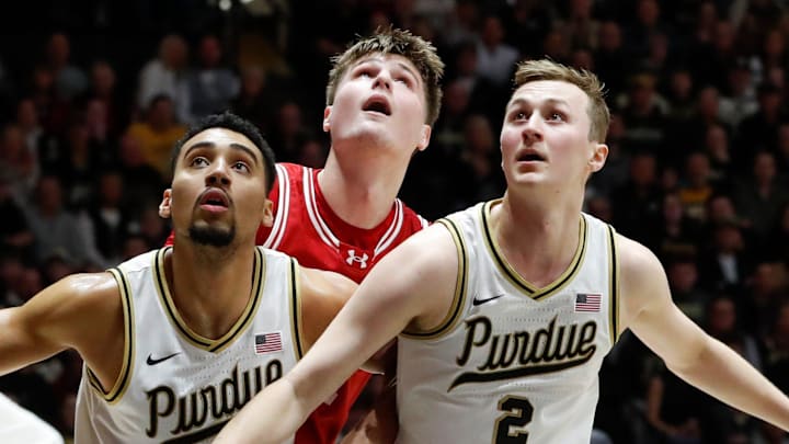 Purdue's Trey Kaufman-Renn (left) and Fletcher Loyer (right) box out Wisconsin forward Nolan Winter (31) during Feb. 15 game at Mackey Arena.
