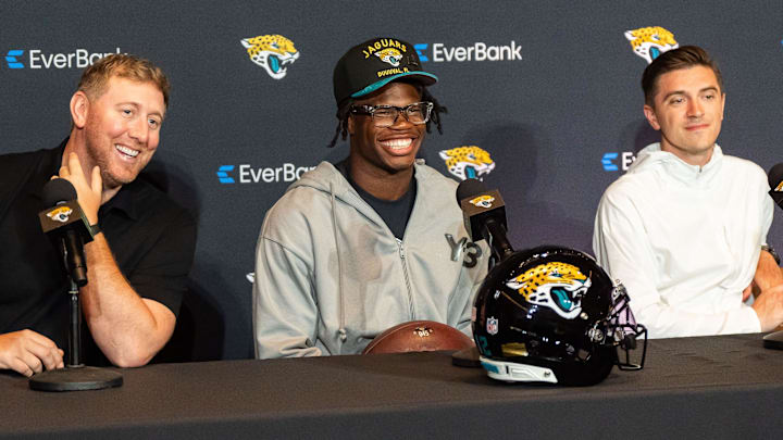 Jacksonville Jaguars ead Coach Liam Coen, left, has a laugh with Jacksonville Jaguars’ first-round pick, Colorado Buffaloes wide receiver and defensive back Travis Hunter, center, during a press conference Friday, March 25, 2025 at Miller Electric Center in Jacksonville, Fla. with General Manager James Gladstone, right. [Doug Engle/Florida Times-Union]