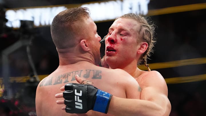 Jan 24, 2026; Las Vegas, Nevada, USA; Justin Gaethje (red gloves) greets Paddy Pimblett (blue gloves) after their fight during UFC 324 at T-Mobile Arena. Mandatory Credit: Stephen R. Sylvanie-Imagn Images